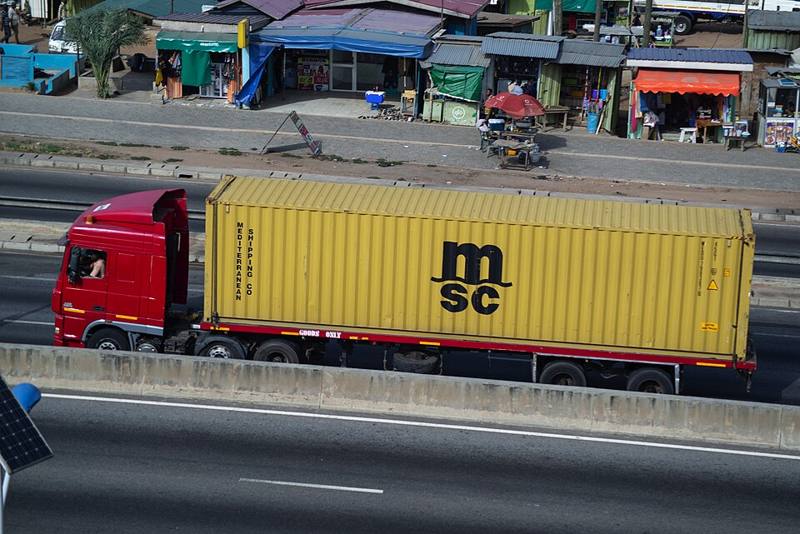 A tractor-trailer parked at a lot